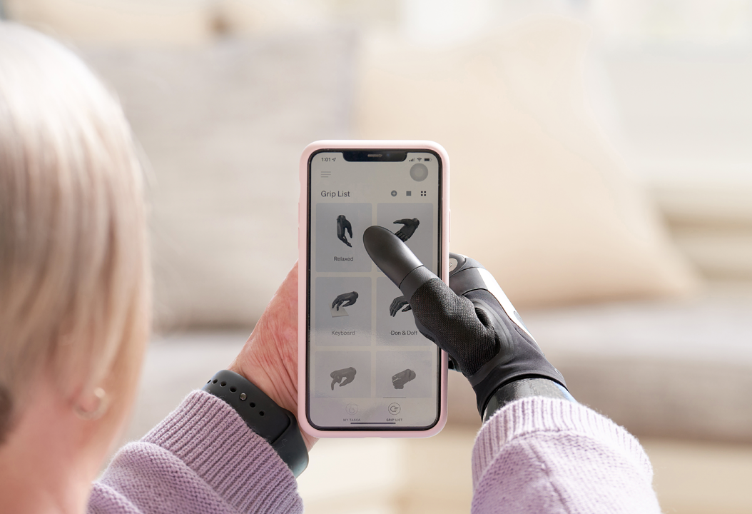 User holding phone with TASKA CX on the MyTASKA app
