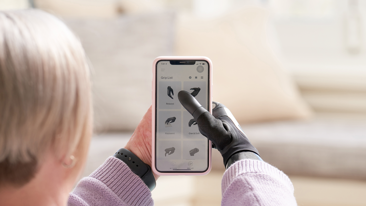 User holding phone with TASKA CX on the MyTASKA app